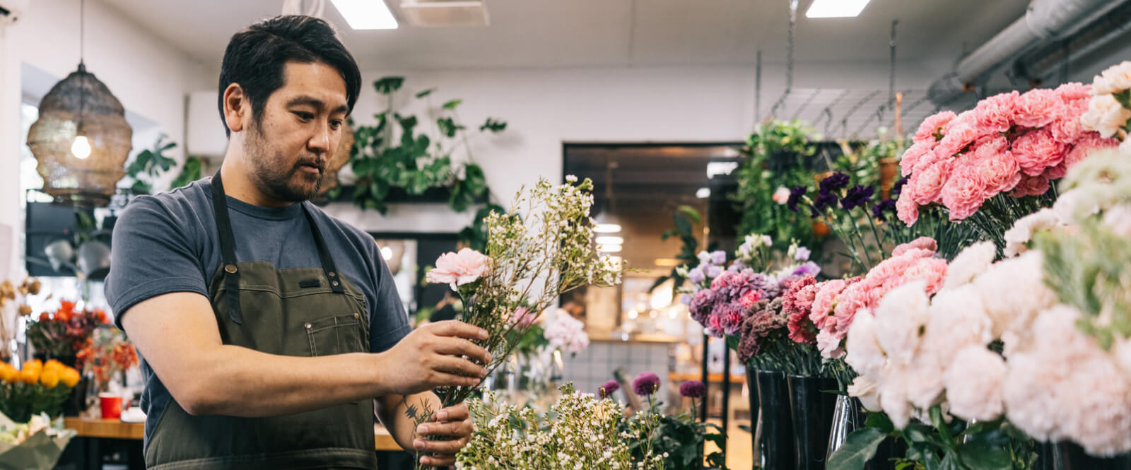 Man in a flower shop arranging flowers