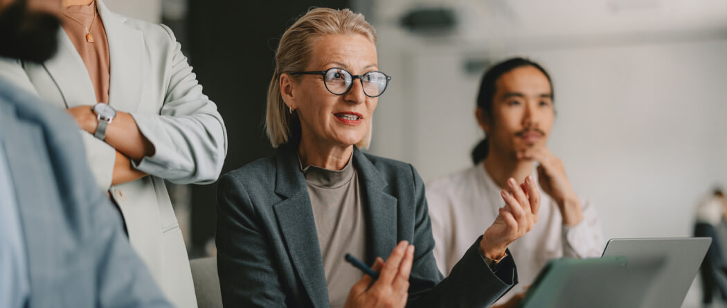 Mature woman in business attire leading a meeting